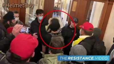 #Helmetboy is wanted by the FBI for questioning. He smashed a window and encouraged Ashley Babbitt to climb through immediately before she was shot. He then ran away.