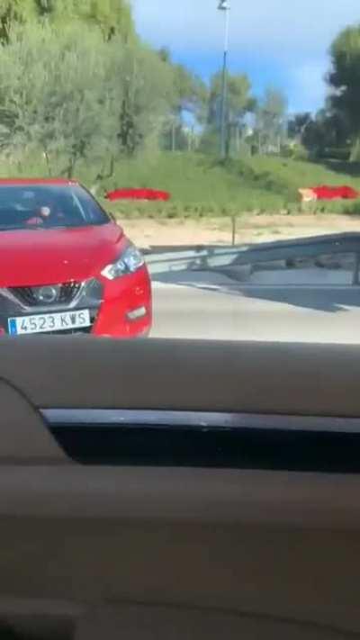 Idiot truck driver doesn't realize he has a car pinned to the front of his truck.