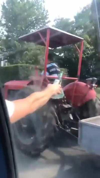 Just some dudes offering a cold one to a farmer on a hot day