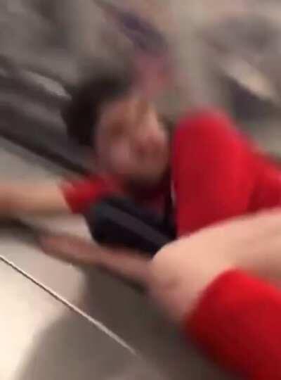 Kid tries to slide down escalator and fails horribly