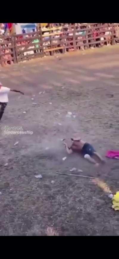 A person attempts to backflip over a bull