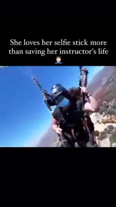 Paragliding instructor dangles without a harness and then falls to the ground. He survived