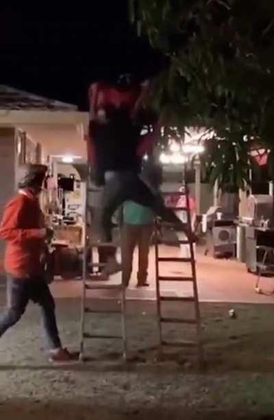 Trying to get a quad bike on a roof with ladders that was a steep ramp