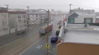 The sheets of rain on the window..