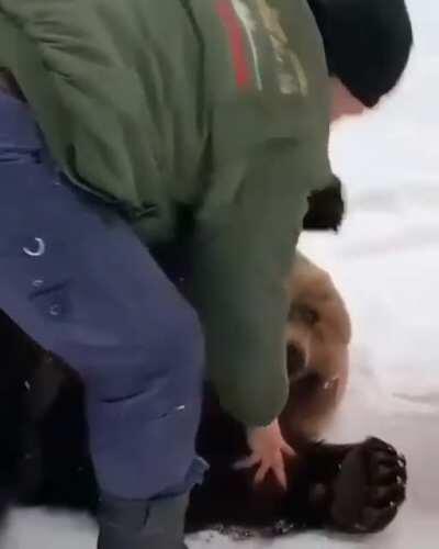 Man playing with a bear