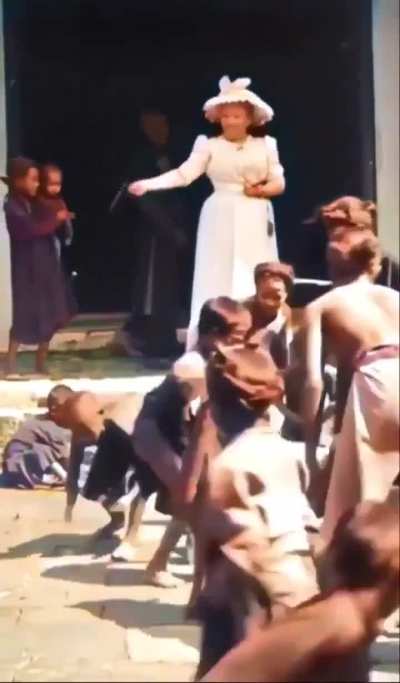 Vietnamese children catching money from women, 1900.