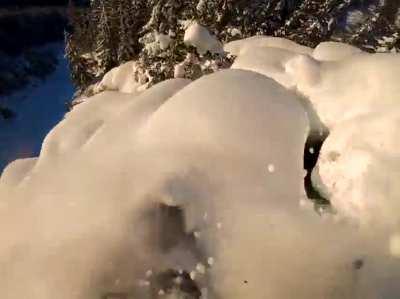 Guy goes snowboarding on a dangerous trail
