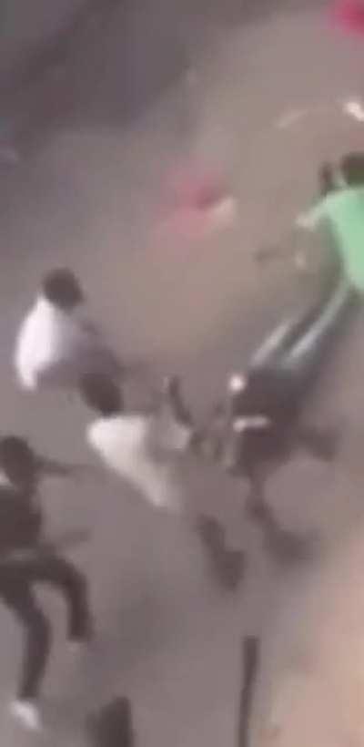 Dude gets knocked out with thrown object during street war