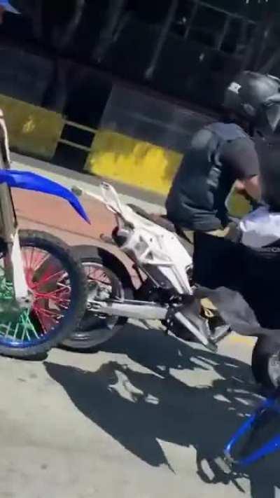 guy doing a wheelie crashes into another guy