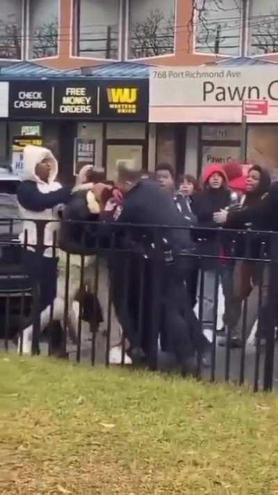 NYPD officer attacking a teenager with closed hammer fists On Richmond Ave In Staten Island near Intermediate School 51