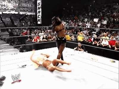 Shaniqa squashes helpless Torrie Wilson in her tiny white bikini. 🤩🤯