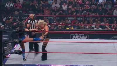 Taya showing Skye Blue no mercy with a hard kick between the legs