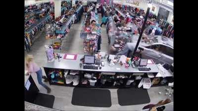 Car drives into store, nearly killing a child.