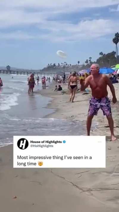 This cool dad showing of his frisbee skills.