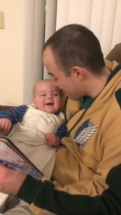 baby girl responding to her new daddy reading a book to her in different voices
