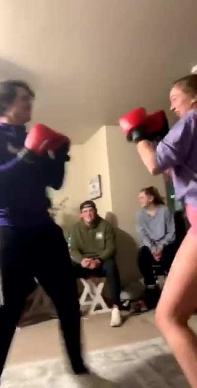 Next best shot wins. Girl slips a punch and lands a solid left hook to knock down her friend.
