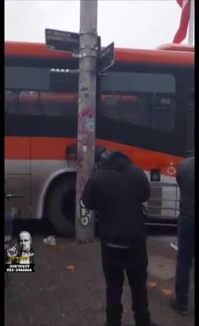 Young woman crushed between a bus and a pole
