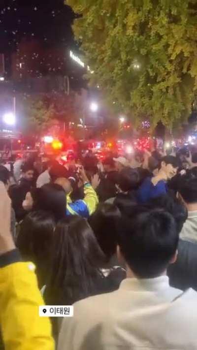 Itaewon, Seoul, S.Korea, while people get squashed and stomped, many critical in need of CPR, rowdy crowd dancing & singing Sex on the Beach, blocking ambulances and the staff.