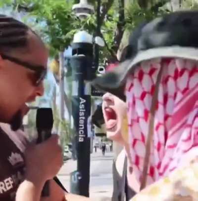 Lady blowing out her vocal cords at street preacher