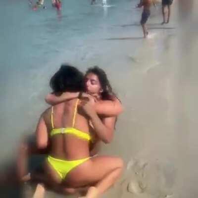 Light wrestling on a public beach