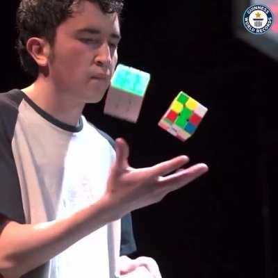Colombian Angel Alvarado solves three Rubik’s Cubes while juggling them