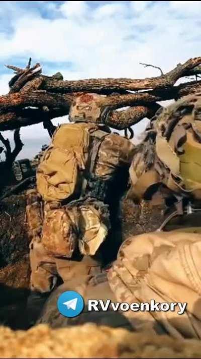 Ru pov: Footage of a Ukrainian soldier geting shot in the helmet as he prepares to fire his machine gun