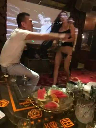 Chinese Waitress serving a bottle of beer