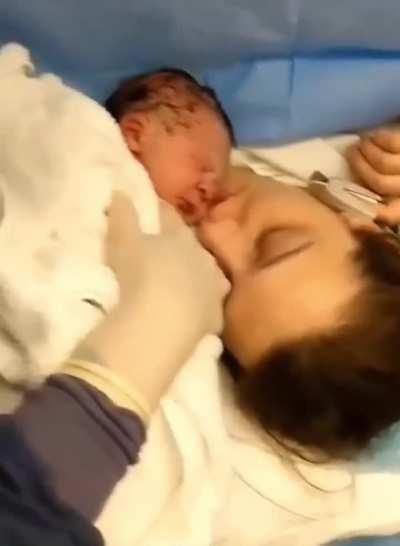 Mother kisses newborn
