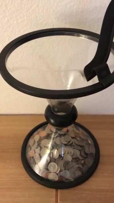 Coins defying gravity in this Parabolic Piggybank