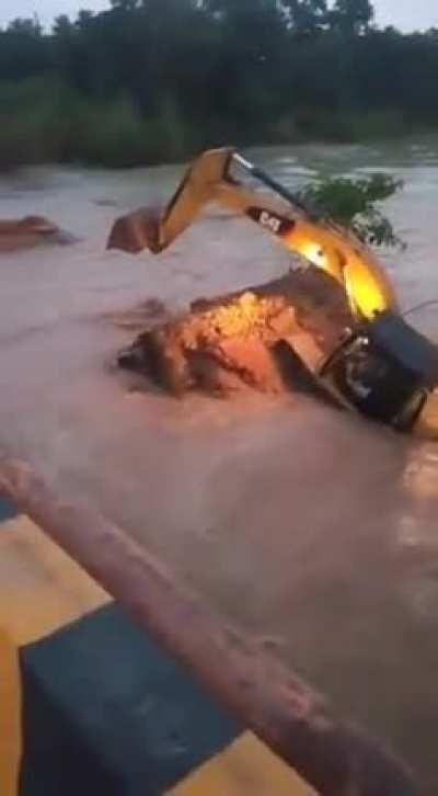 Excavator drops into river while demolishing a bridge. (cant find main source)