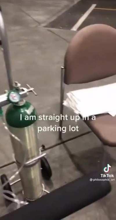 Hospital patient in hysterical disbelief as she's treated in the parking lot