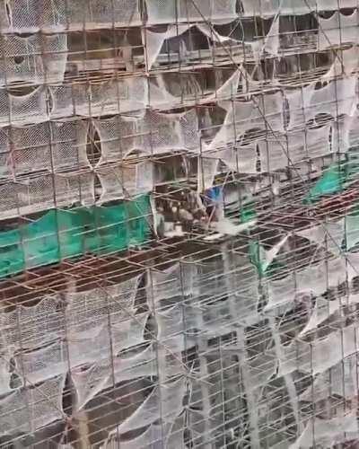 Chinese bamboo scaffolding on a sheer cliff face.