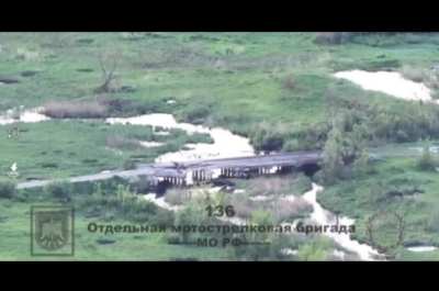 Russian Kh-38 air-to-surface missile hits a river bank, nearly missing a bridge and most likely hits an AFU soldier that was crossing the bridge