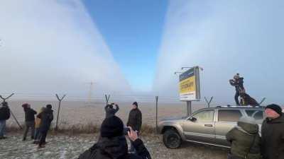 Worlds largest plane cutting through fog as it lands.