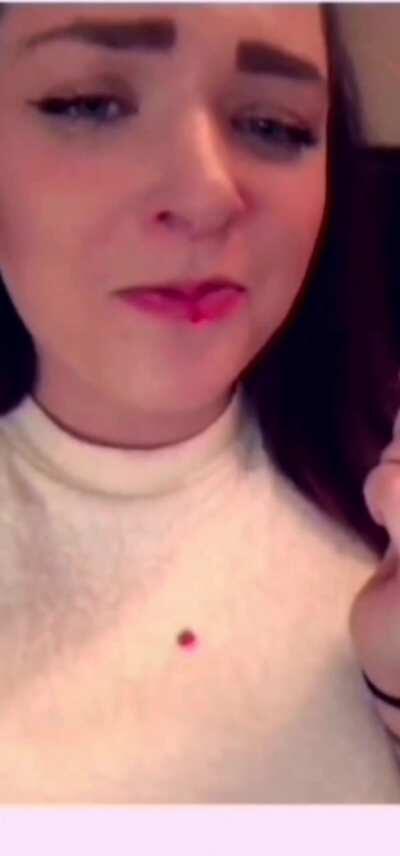 Eating a strawberry the sexy way while wearing a white sweater