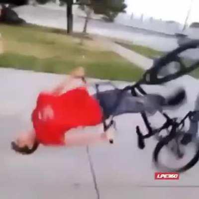 Idiot trying to ride bike through plastic wrap