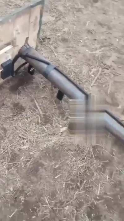 Russian soldier fires an improvised portable rocket launcher built from scrap materials with intense recoil. Time and location unknown