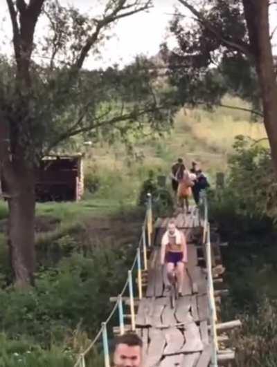 Crossing this rickety bridge on a bike