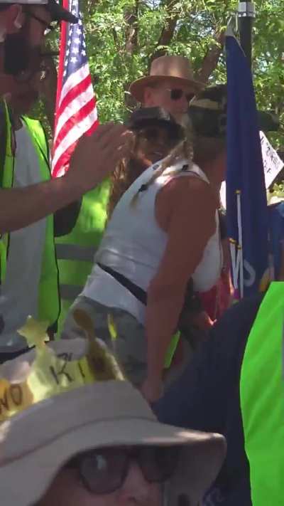 Republican Agitator tries to go for her gun at peaceful protest. She is thrown to the ground and arrested.