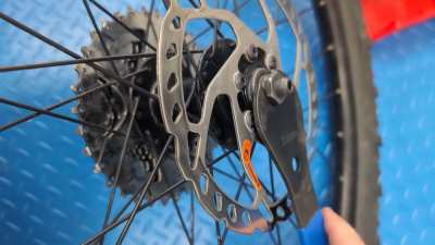 Mountain bike wheel not spinning freely — axle builds tension then clicks/releases