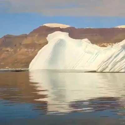 An iceberg rolling over