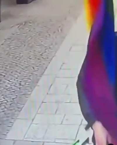 Two guys pull down pride flags from a gay bar in Paris.