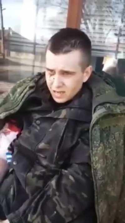 Wounded Russian soldier being treated by Ukrainian soldier