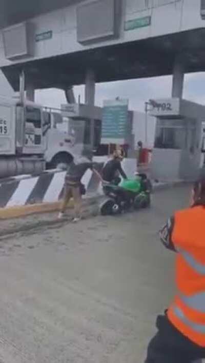 Idiot wanted to avoid paying the toll through a closed booth, gets stuck in fresh concrete instead.