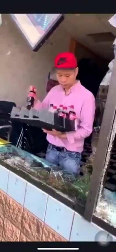 Storeowner finds what's left of his store after the protest as cameraman steals from him and laughs