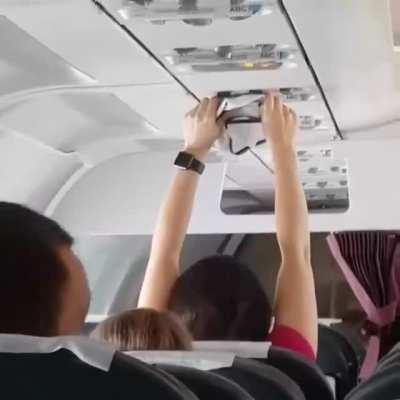 A woman dries her underwear on a plane