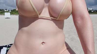Enjoying a beautiful day at the beach with a sheer nude top and a C-string