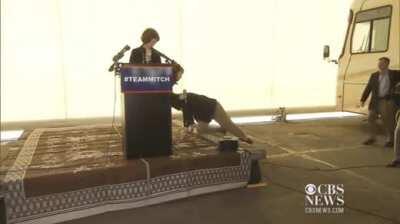 McConnell falls on his face, his wife just stands there and his security guard goes for his GUN