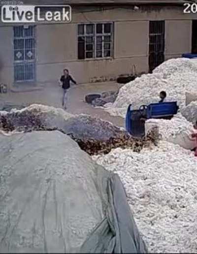 Using a lighter to open a bag at a cotton warehouse