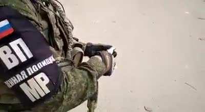 A Russian soldier treats a Syrian boy to ice cream.